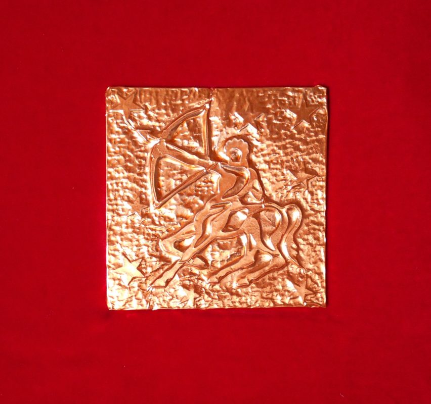 Esempio di segno zodiacale montato su pannello rivestito in velluto rosso